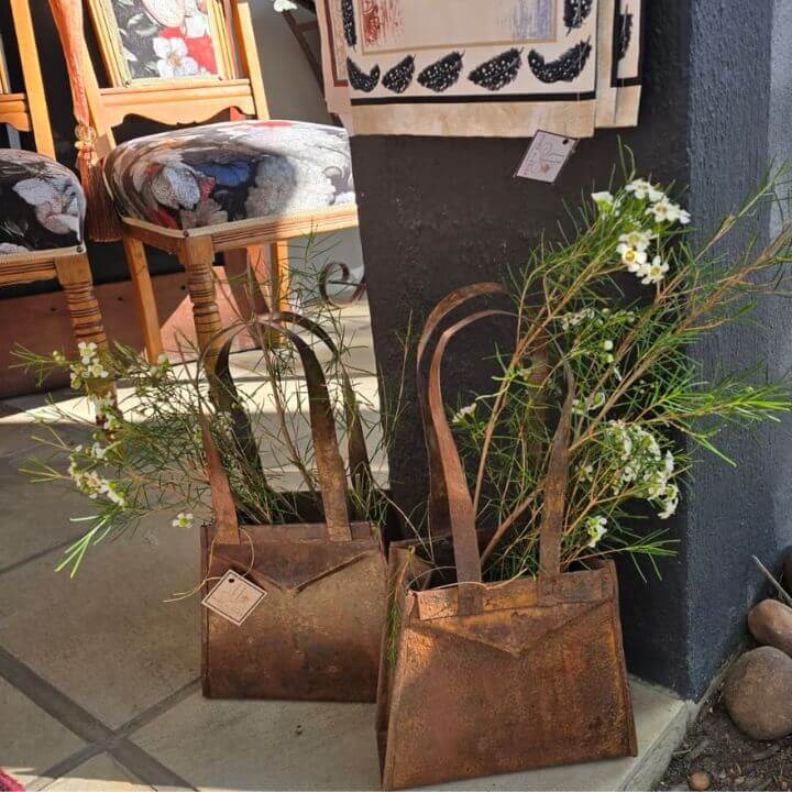 home and gift boutique cape town. metal crafted bags with floral, antique chairs at pure plesier